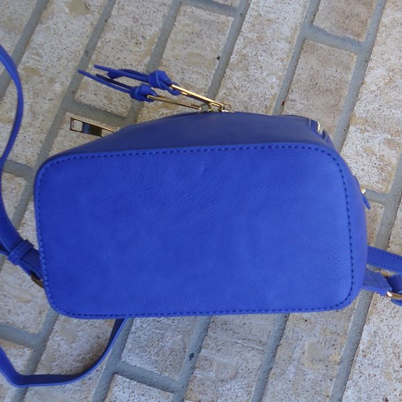 Mini backpack purse with gold tone zippers.